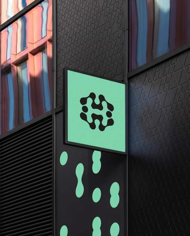 A mint House sign mounted on a charcoal architectural facade.